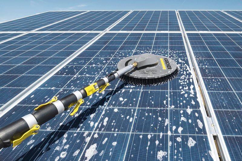 Brush cleaning a soiled solar panel